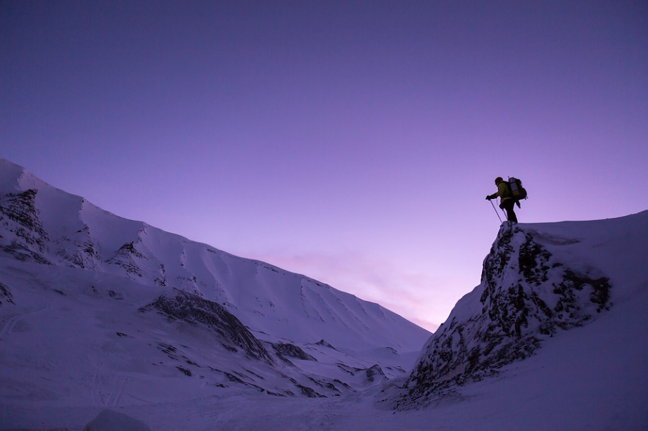 a hiker standing on the peak